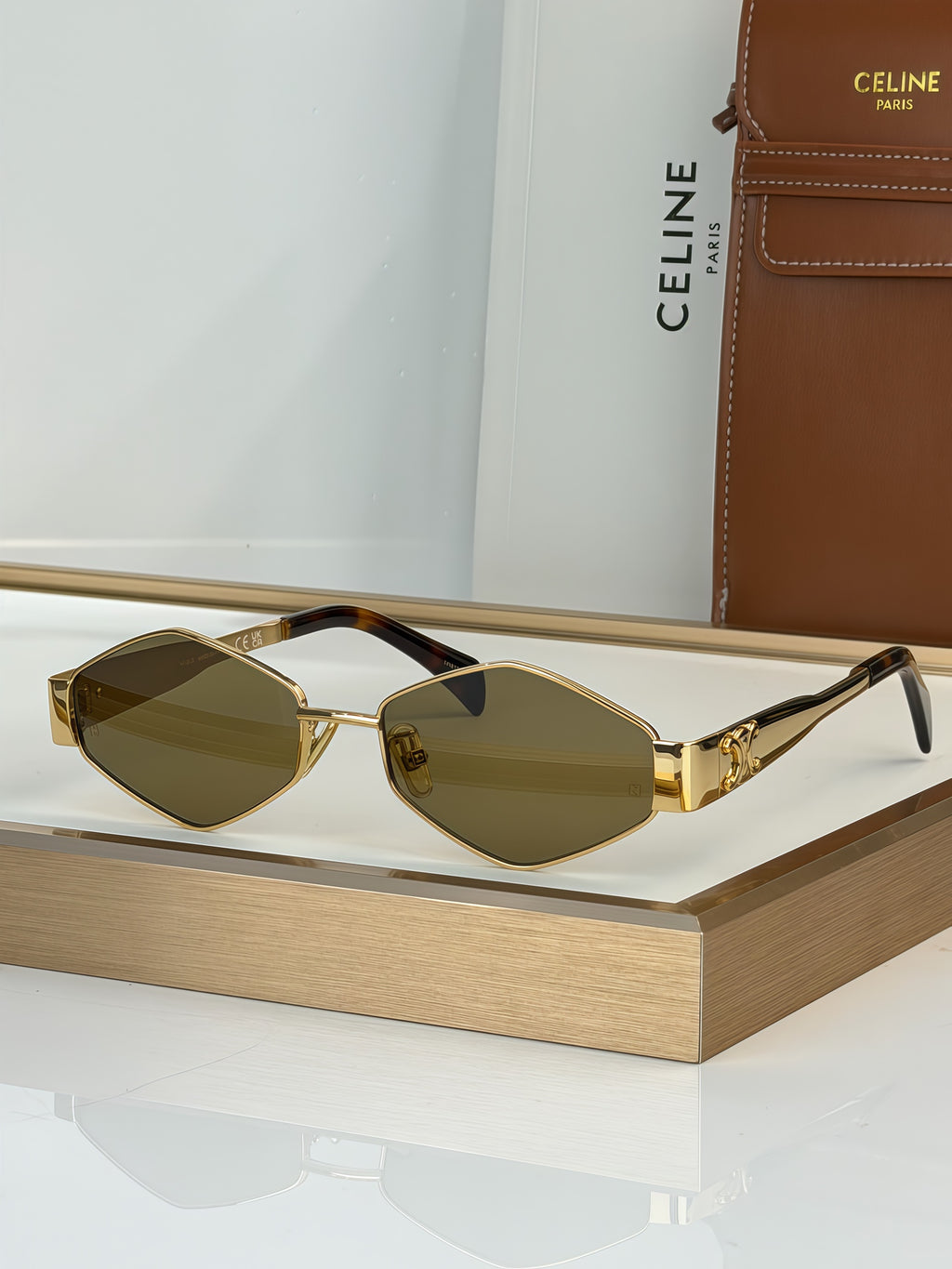 Celine sunglasses with gold-tone frame and dark brown gradient lenses, black arms