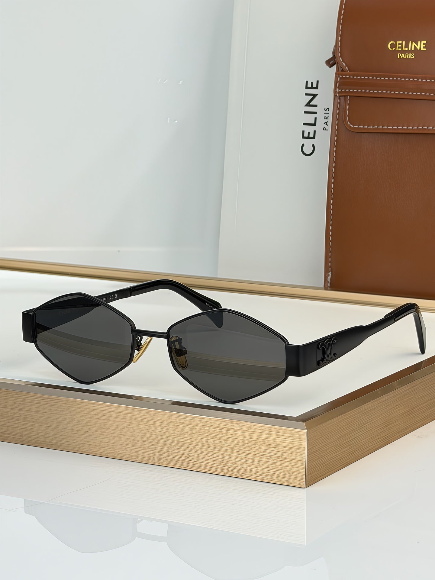 Celine sunglasses with black frame and dark gray lenses, gold-tone temples