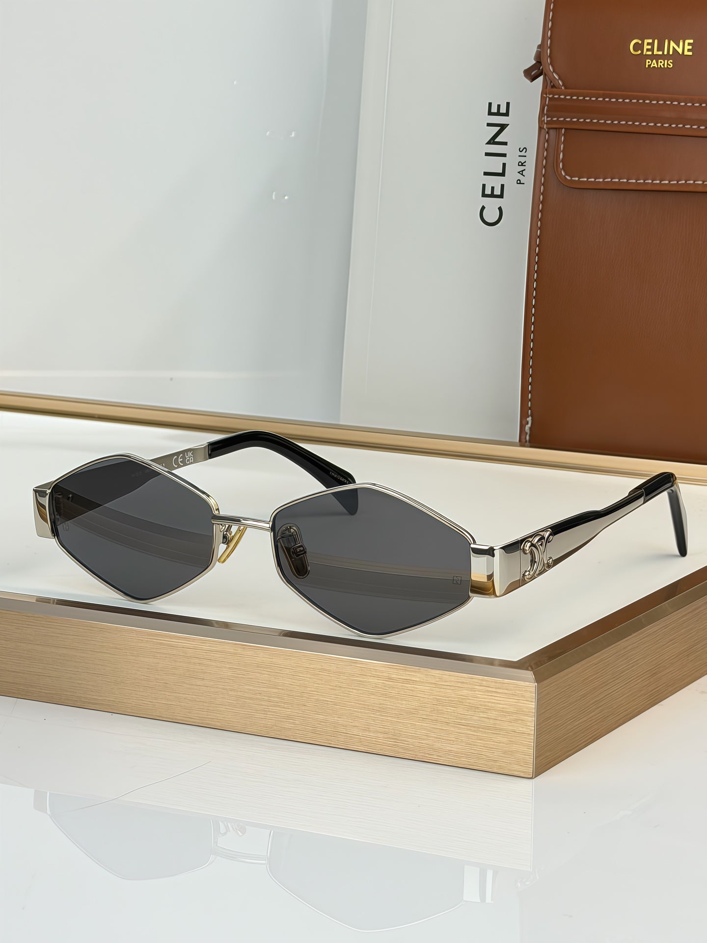 Celine sunglasses with black frame and dark gray lenses, gold-tone temples