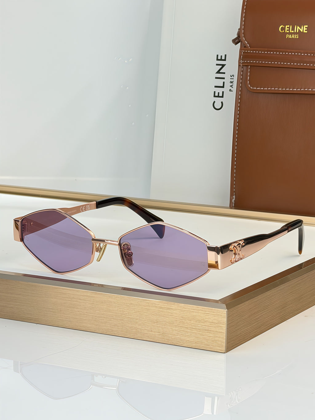 Celine sunglasses with gold-tone frame and purple gradient lenses, black arms