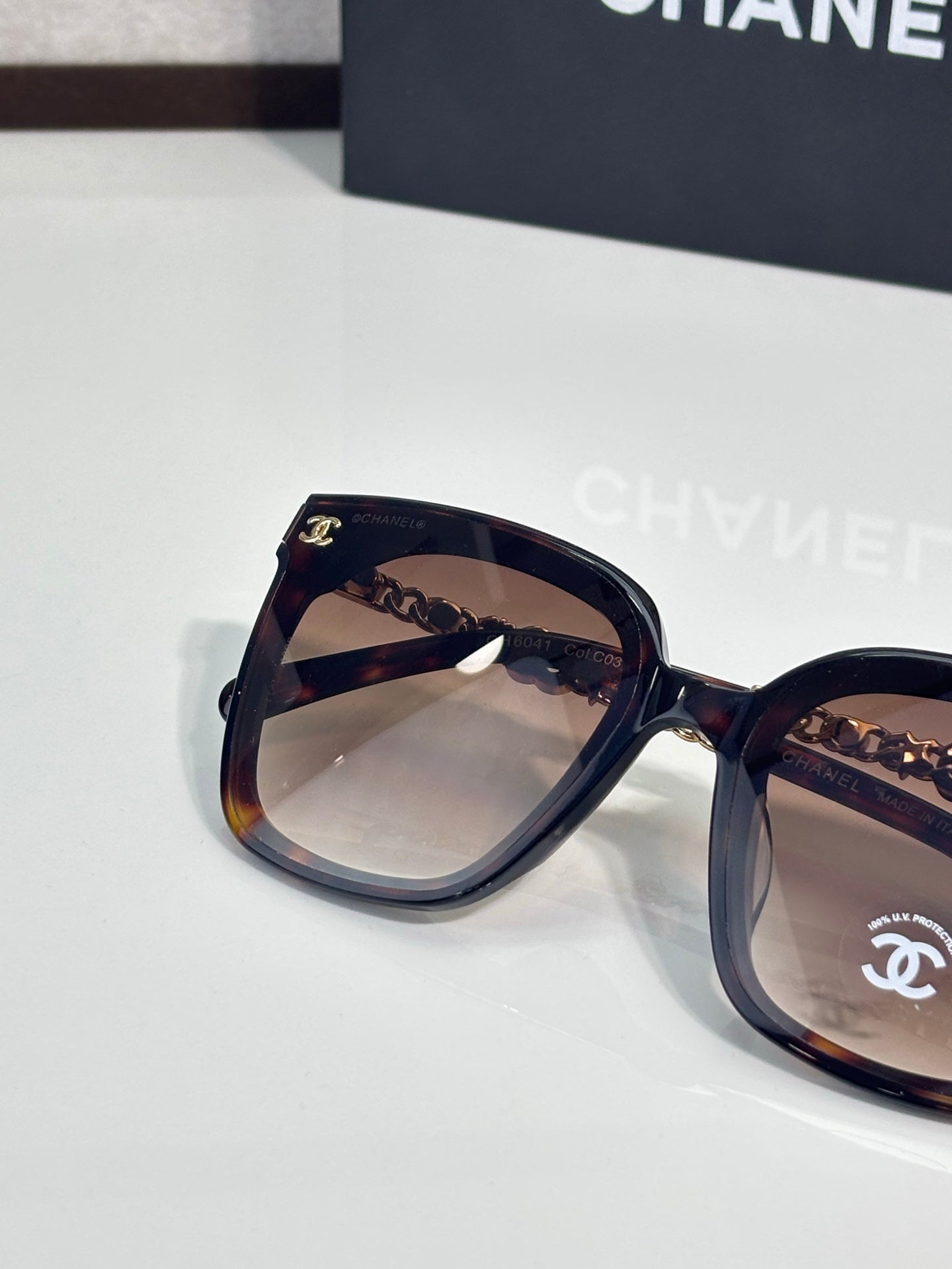 Chanel sunglasses close-up with tortoiseshell frame and tinted lenses