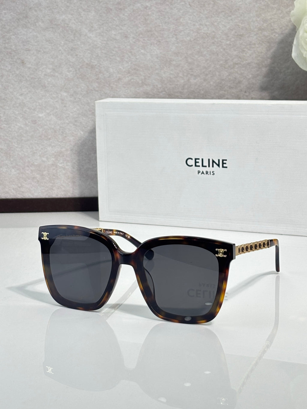Celine square sunglasses with dark lenses, tortoise front and gold-tone chain temple details