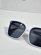 Celine sunglasses close view: white frame with dark lenses and gold-tone accents