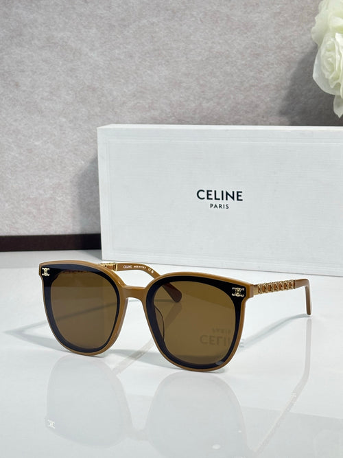Sunglasses with gold frame and brown-tinted lenses, tortoiseshell arms with logo studs