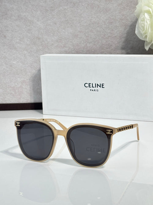 Gold sunglasses with dark lenses, tortoiseshell arms and logo stud accents