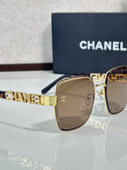Chanel square sunglasses with brown lenses, gold-tone frame, dark blue temple tips