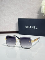 Chanel square sunglasses with smoky lenses, silver frame, gold temple accents