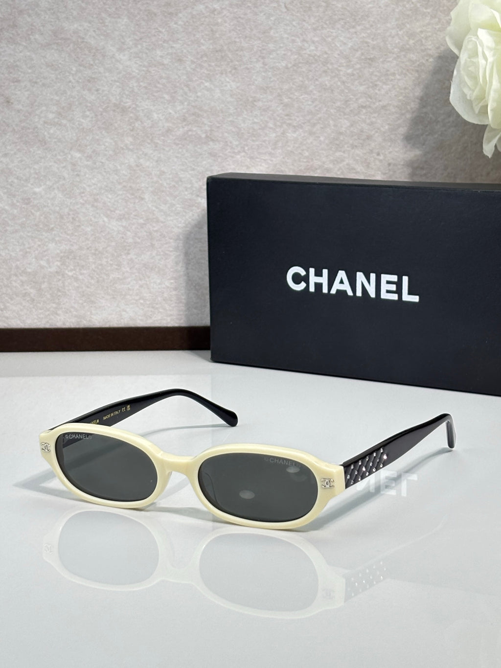 Chanel eyeglasses with ivory frame and dark tinted lenses