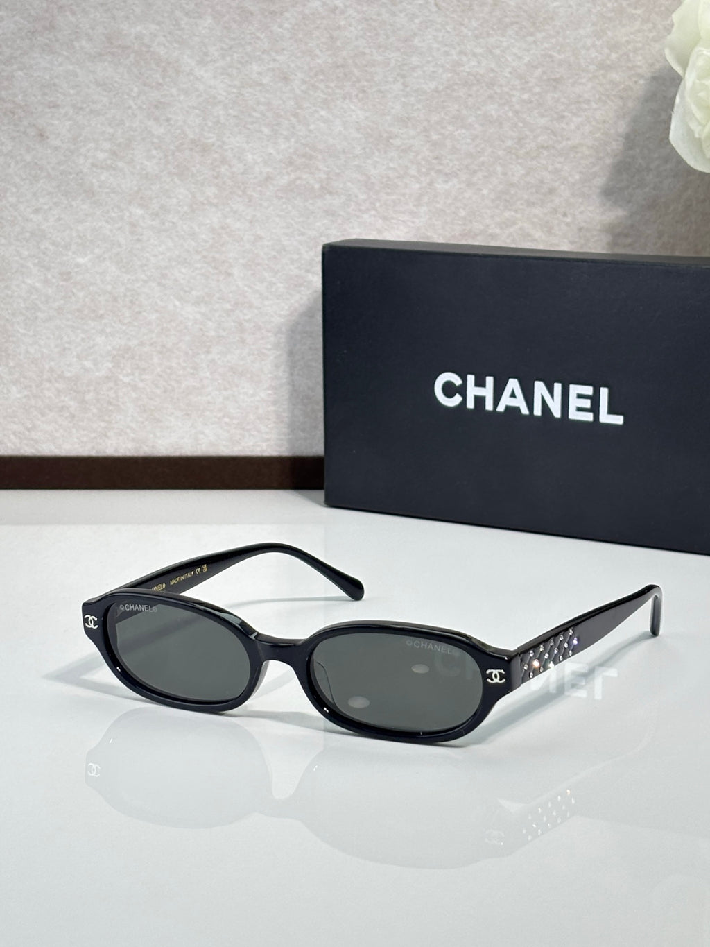 Chanel eyeglasses with black oval frame and dark tinted lenses
