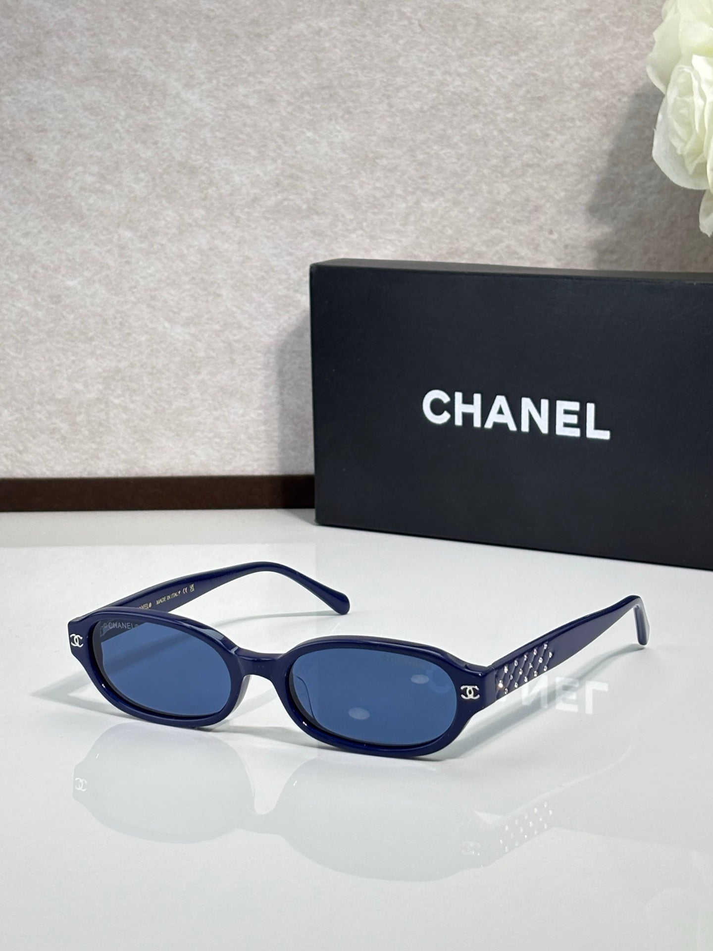 Chanel eyeglasses with navy frame and blue-tinted lenses