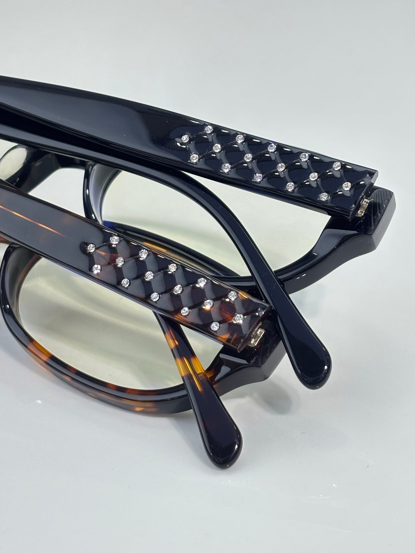Chanel eyeglasses close-up: black and tortoiseshell frames with studded temples