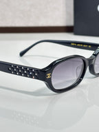 Chanel eyeglasses close-up: black frame with studded temple and clear lens