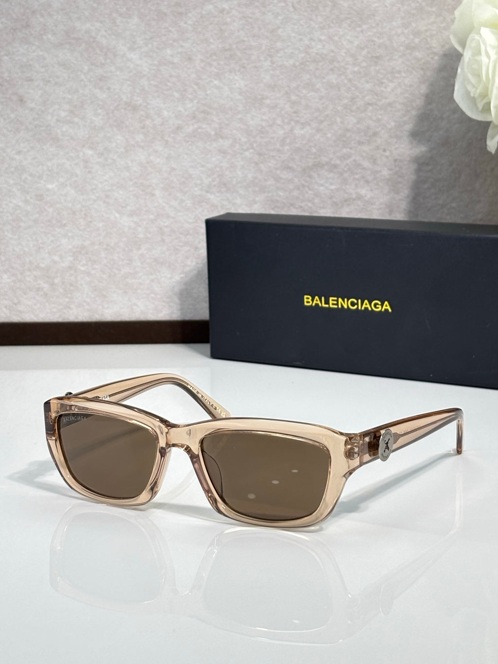 Balenciaga sunglasses with gold frame and brown-tinted lenses