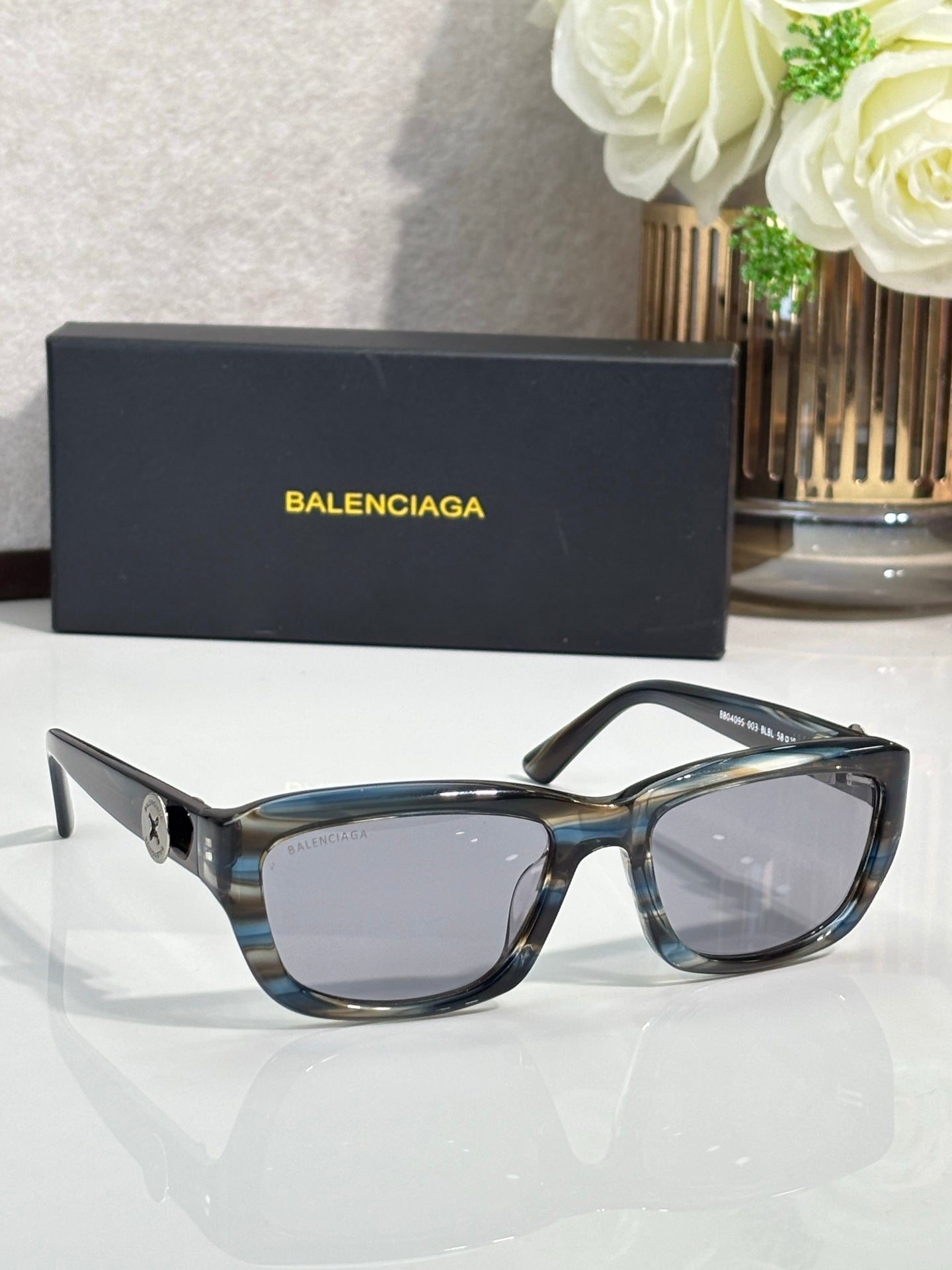 Balenciaga sunglasses with blue tortoise frame and clear-tinted lenses