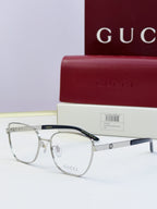 Gucci eyeglasses with silver frames and clear-to-dark lenses; dark temples; includes Gucci case.