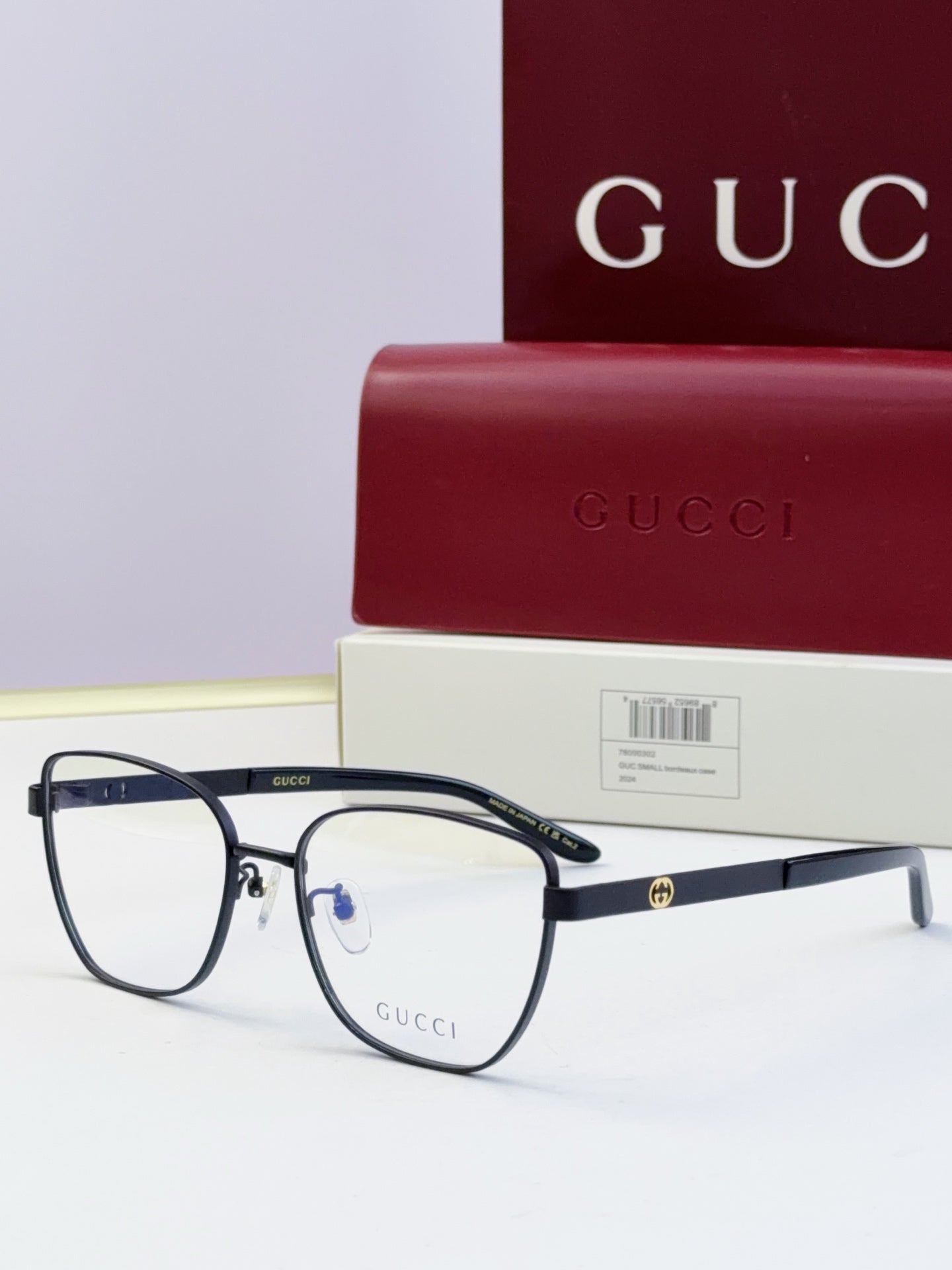 Gucci eyeglasses with black frames and clear-to-dark lenses; black temples; includes Gucci case.