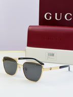 Gucci eyeglasses with gold frames and dark lenses; black temples; includes Gucci case.