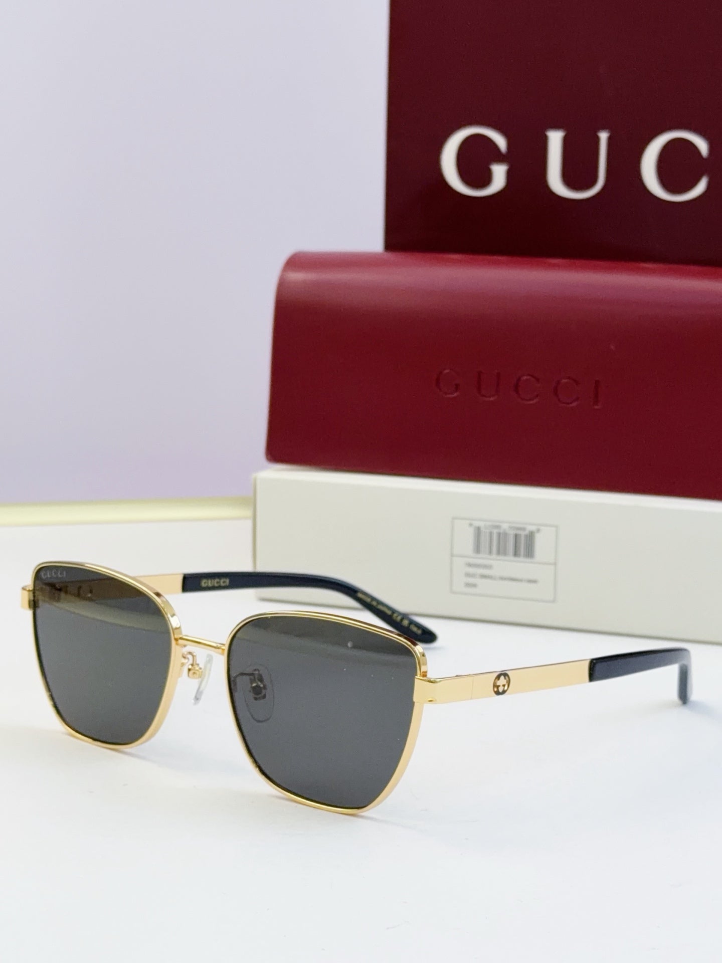 Gucci eyeglasses with gold frames and dark lenses; black temples; includes Gucci case.