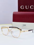 Gucci eyeglasses with gold frames and dark lenses; tortoise temples; includes Gucci case.