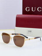 Gucci eyeglasses with gold frames and brown lenses; tortoise temples; includes Gucci case.