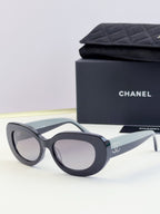 CHANEL sunglasses with dark lenses and black cat-eye frame, side angle