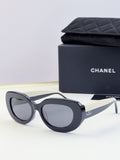 CHANEL sunglasses with dark round lenses and black cat-eye frame