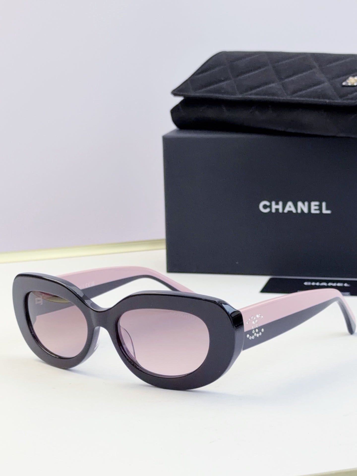 CHANEL sunglasses with dark frame and light pink tinted lenses