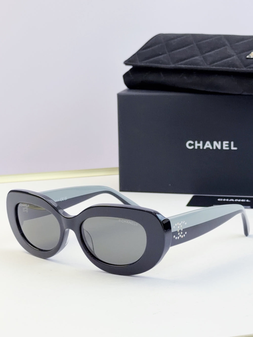 CHANEL sunglasses with dark lenses and black cat-eye frame, front view