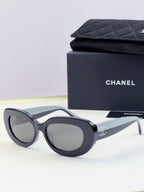 CHANEL sunglasses with dark lenses and black cat-eye frame, front view