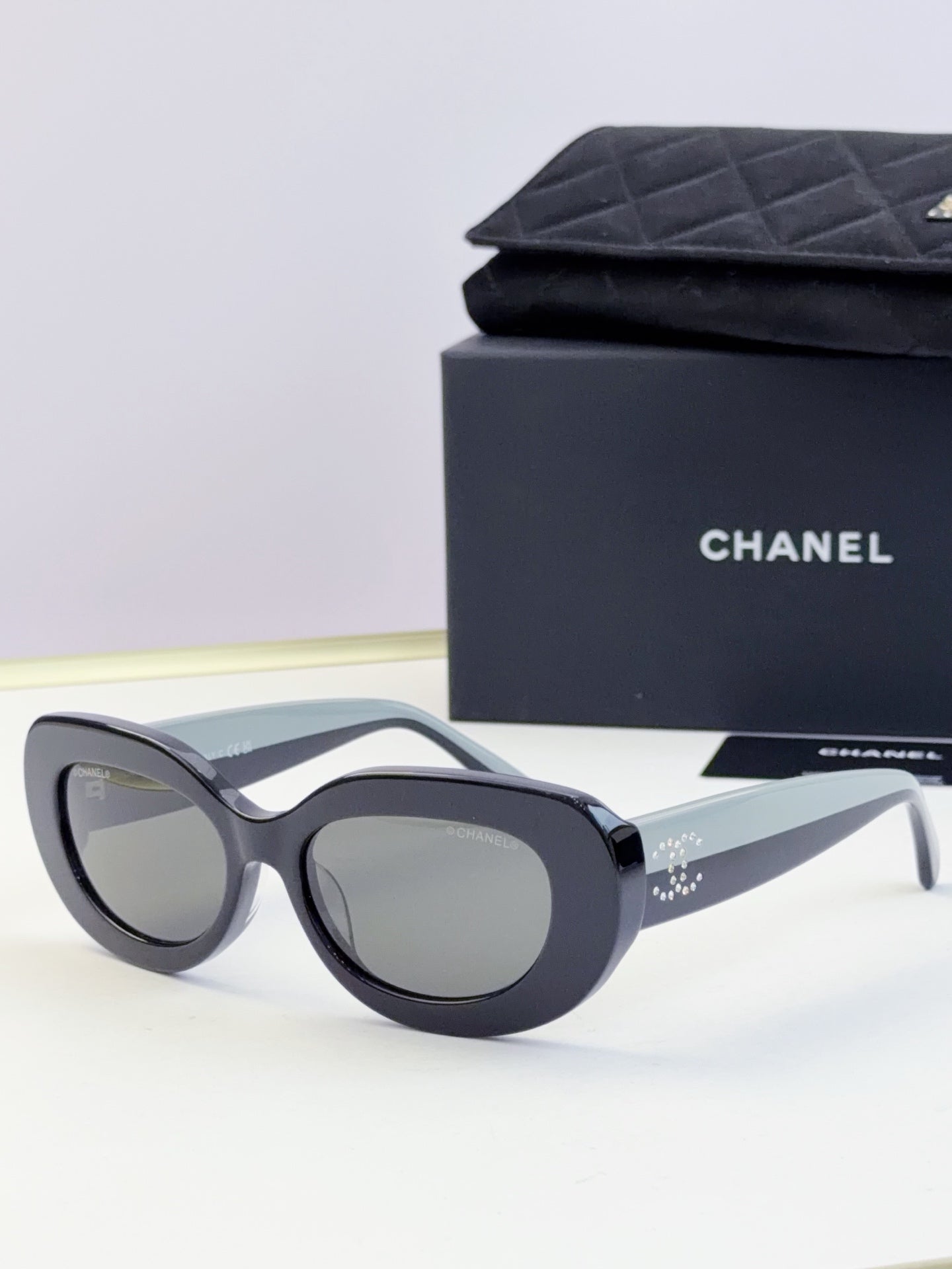CHANEL sunglasses with dark lenses and black cat-eye frame, front view