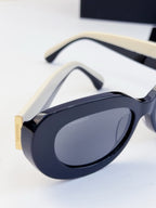 CHANEL sunglasses close-up of curved frame and tinted oval lenses