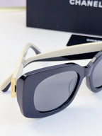 Chanel sunglasses close-up with white temples and dark blue lenses