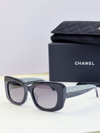 Chanel sunglasses with dark blue frames and pale tinted lenses