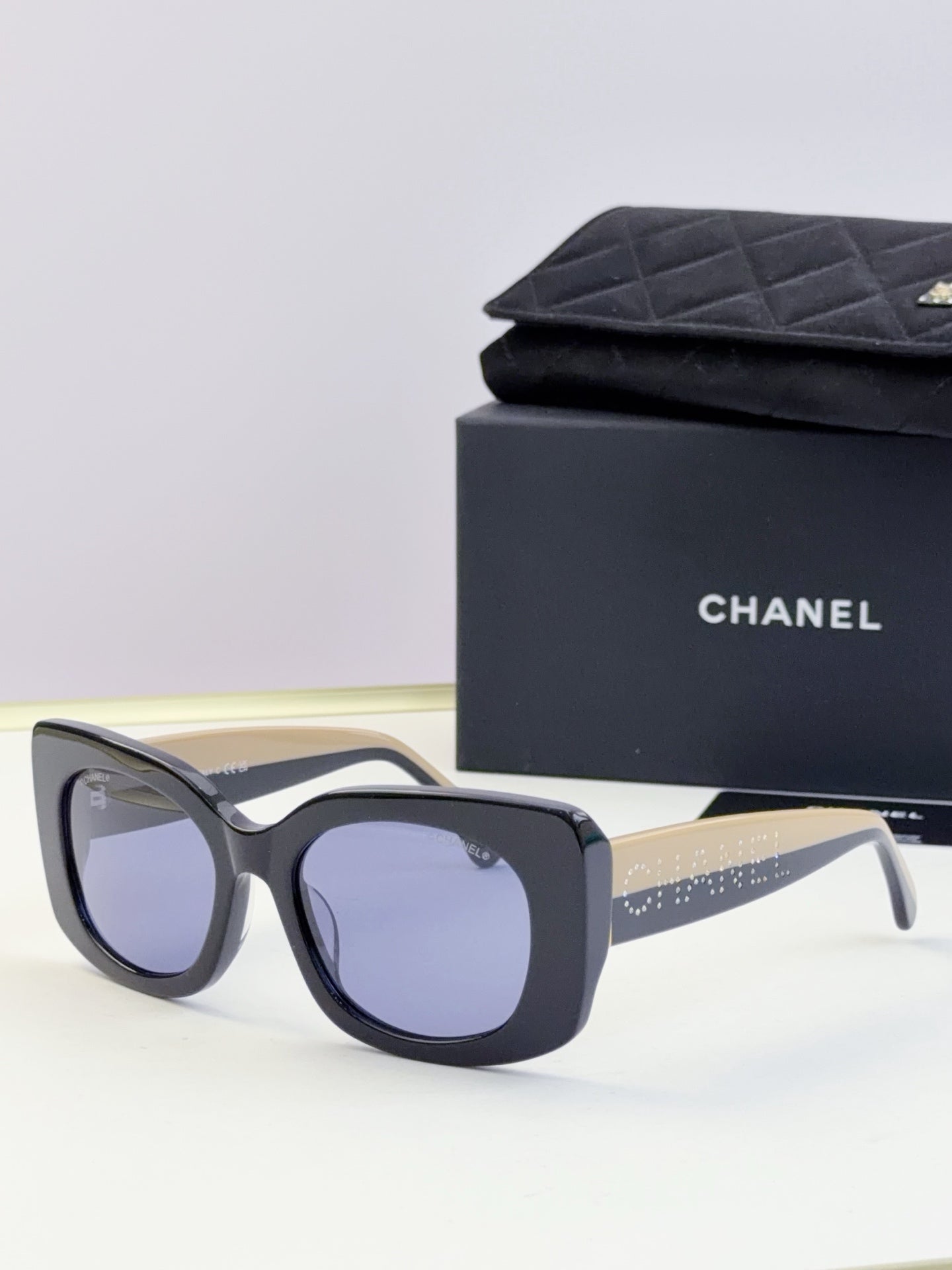 Chanel sunglasses with dark blue frames and light gray lenses