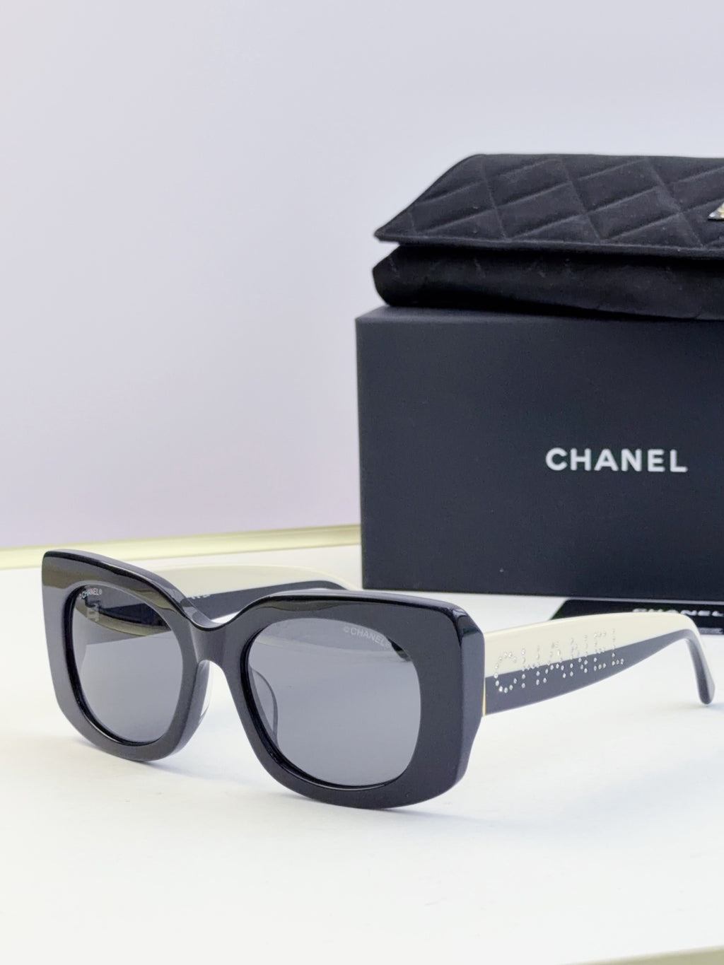 Chanel sunglasses with dark blue frames and light gray lenses