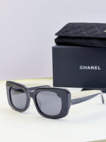 Chanel sunglasses with dark blue frames and light gray lenses