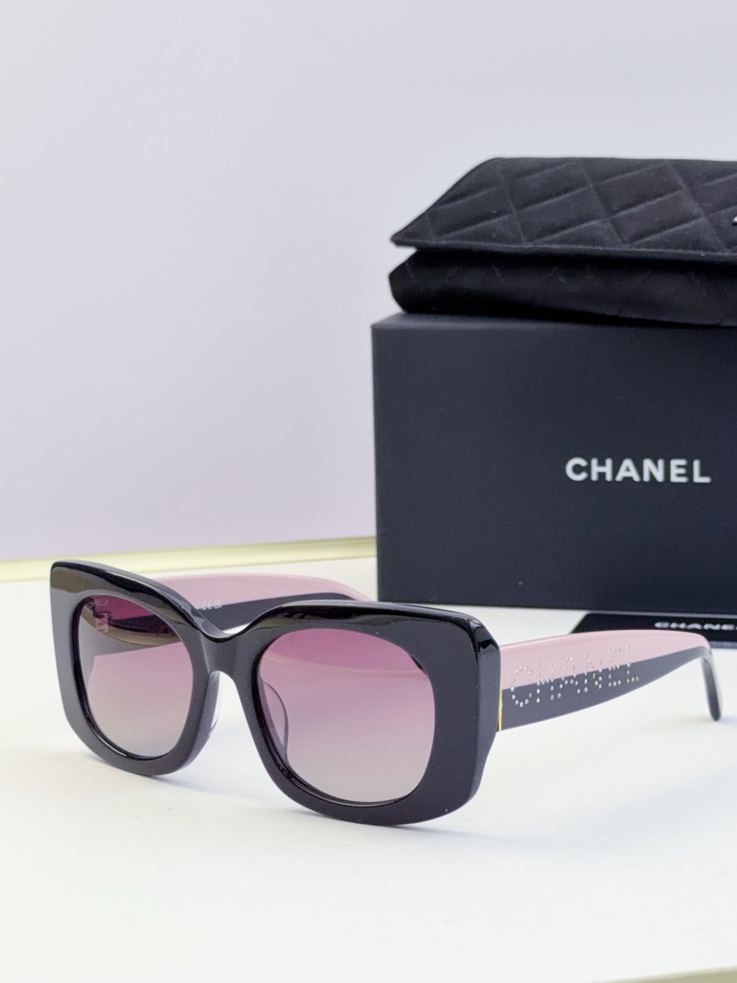 Chanel sunglasses with dark blue frames and pink tinted lenses