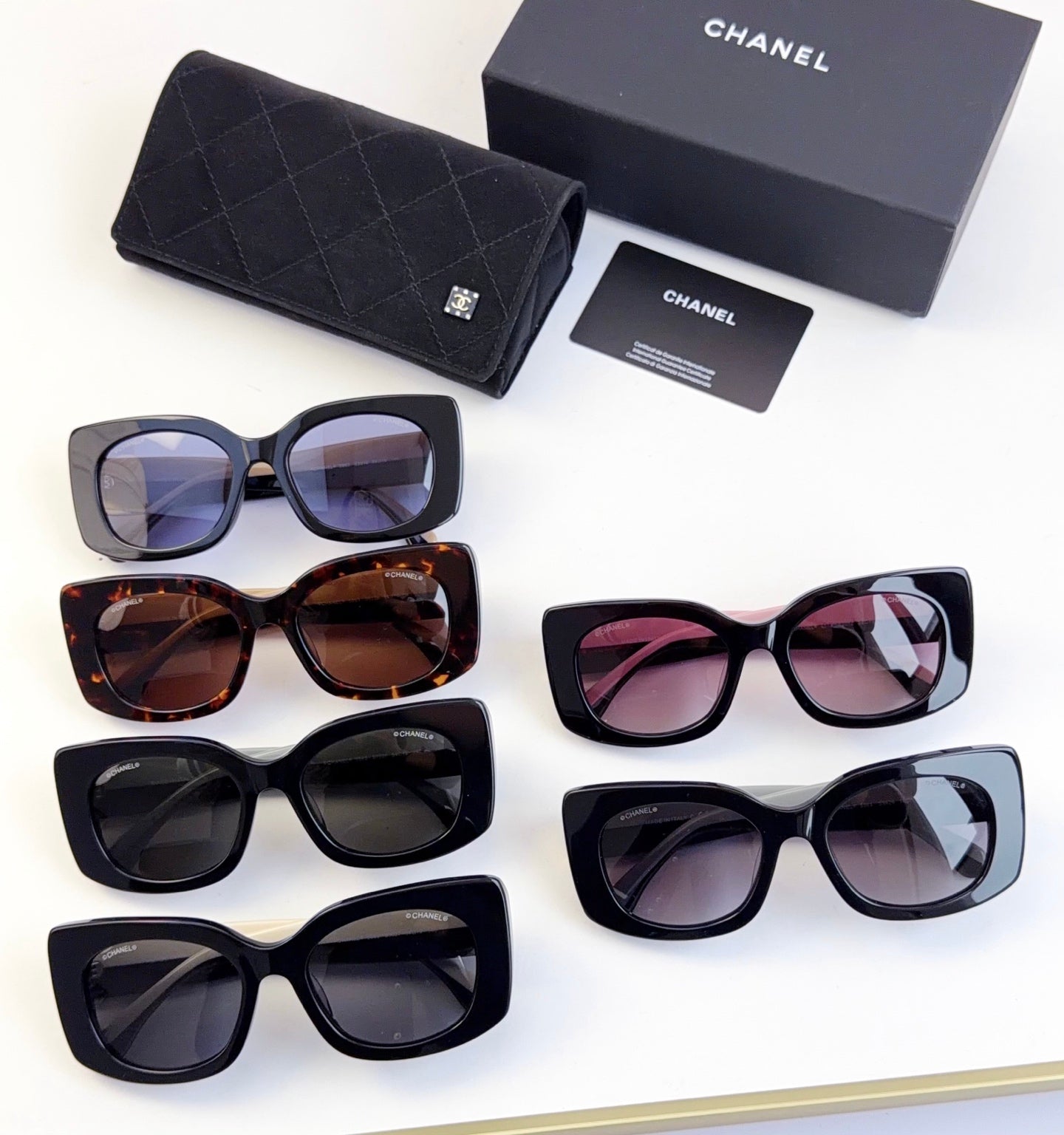 Assorted Chanel sunglasses with black, brown, pink, and gray frames and tinted lenses