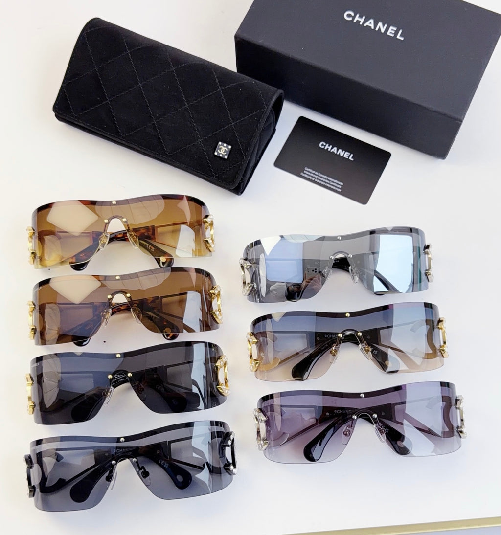 Set of CHANEL sunglasses with mixed lens colors, gold-tone frames, and matching case