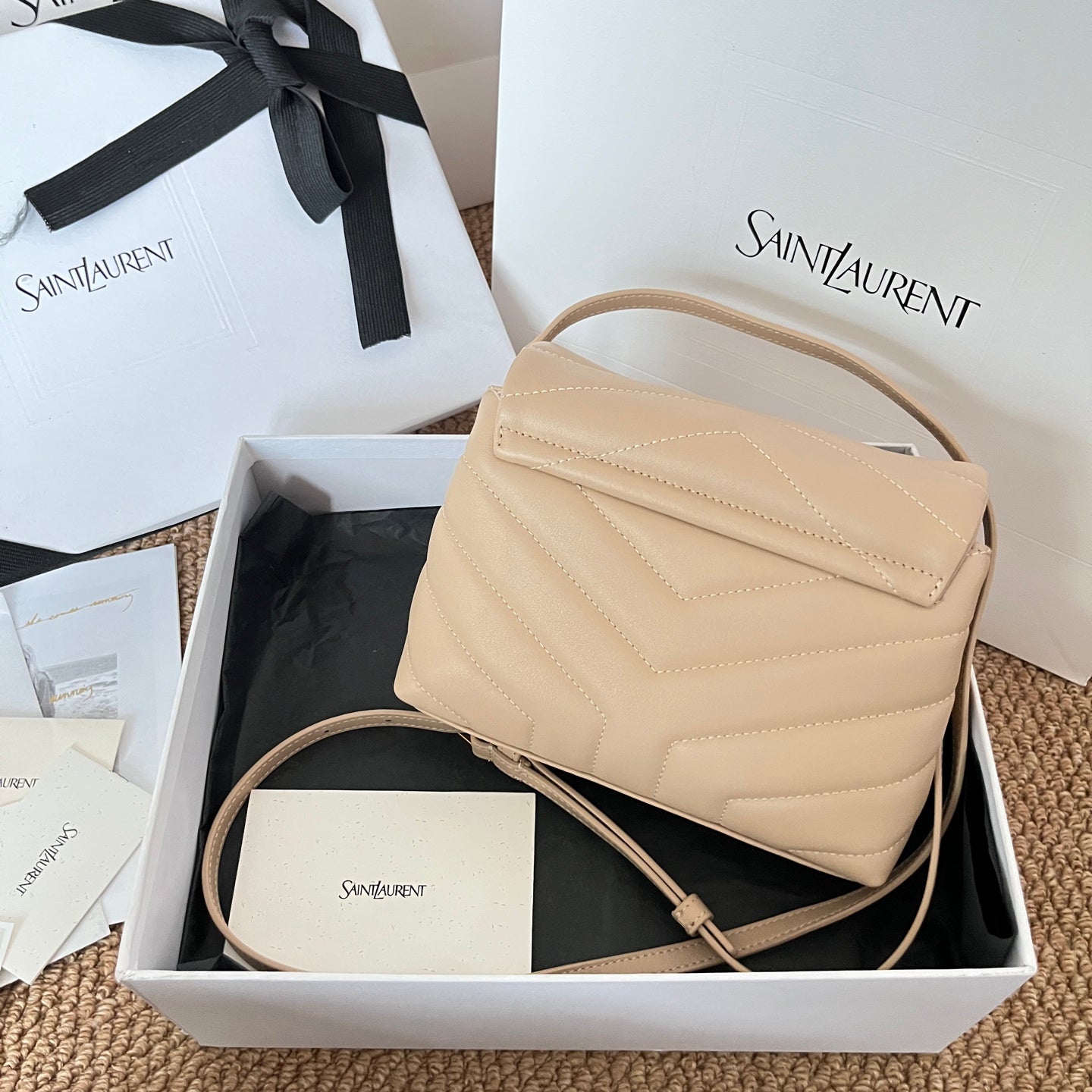 Beige quilted YSL shoulder bag with flap, front logo, and crossbody strap