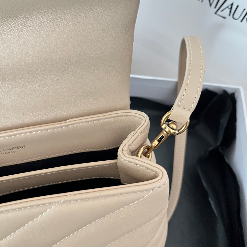 Beige YSL shoulder bag strap with gold hardware and stitched trim