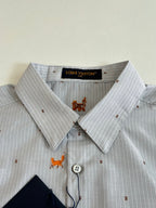 Light blue striped dress shirt collar with orange dog embroidery and button placket