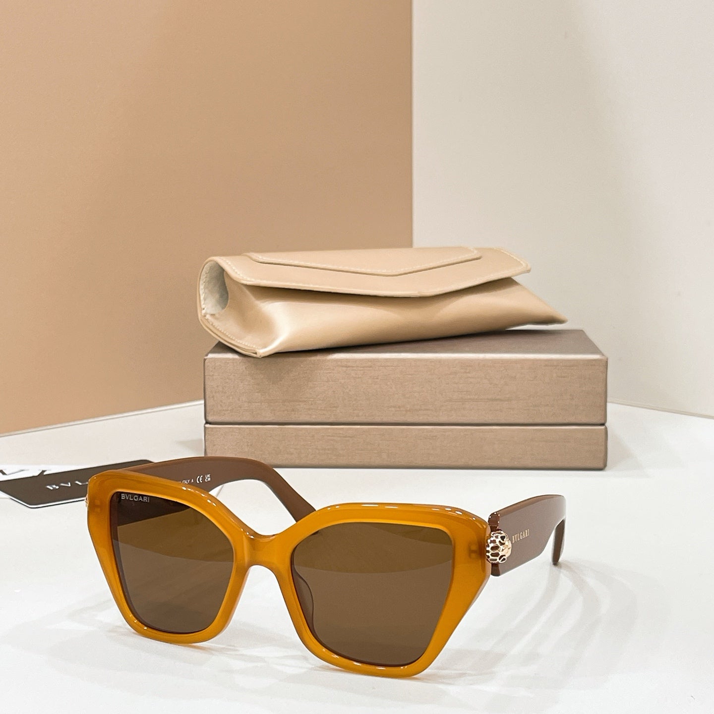 Bvlgari cat-eye sunglasses with orange frames and dark brown lenses