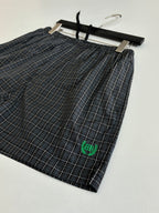 Balenciaga plaid shorts with elastic waist, black tie and green logo patch