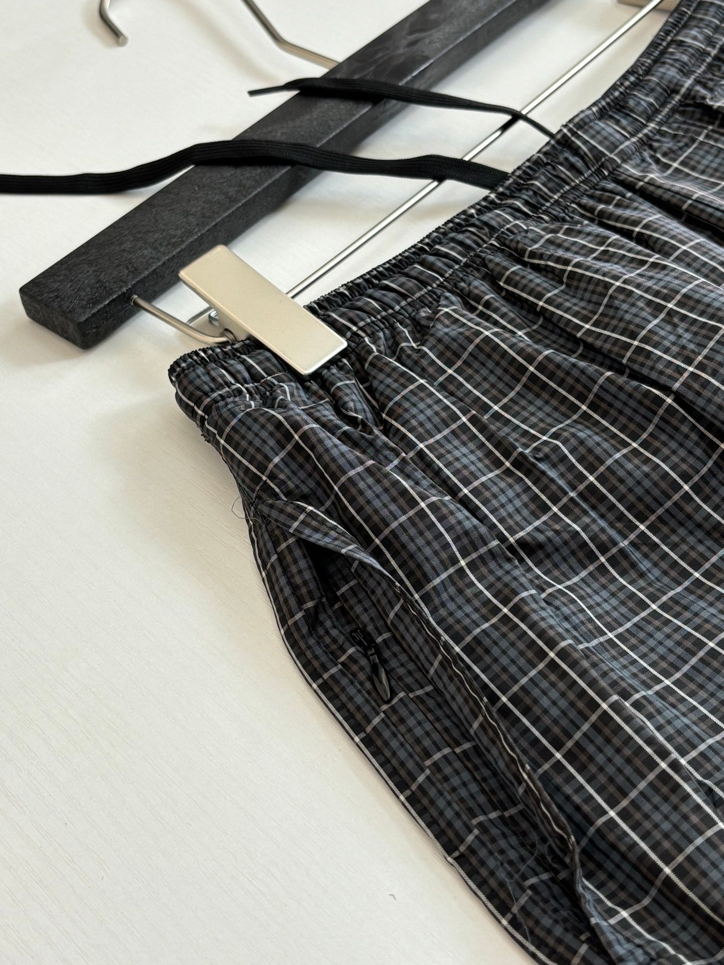 Balenciaga plaid shorts detail with elastic waist and drawstring, dark check fabric