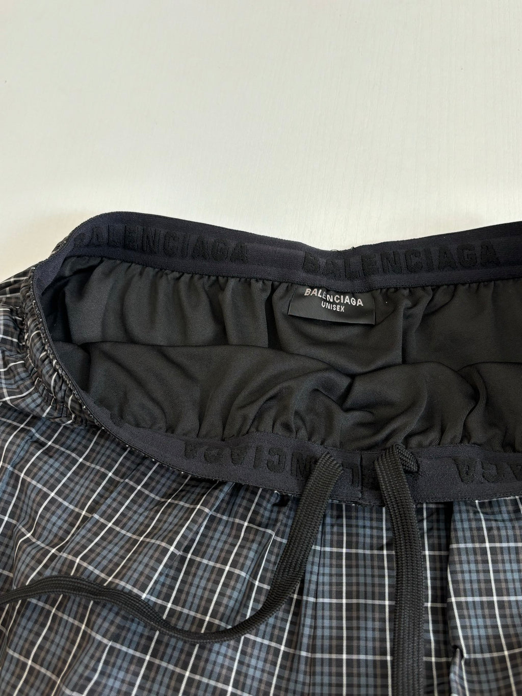Balenciaga logo waistband on plaid shorts with black drawstring tie