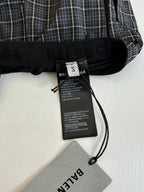 Balenciaga care label tag on black waistband of plaid shorts