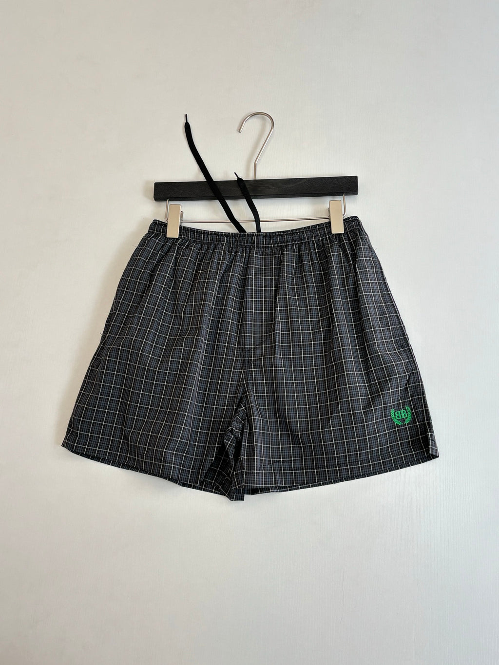 Balenciaga plaid shorts with elastic waistband and small green logo on leg