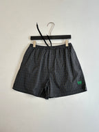 Balenciaga plaid shorts with front seams and green logo patch