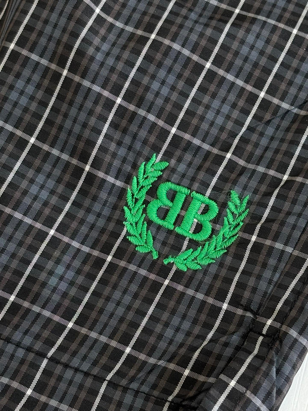 Green Balenciaga BR logo patch on dark plaid shorts